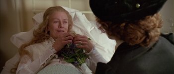 Movie still from “Howards End” (1992), directed by James Ivory – An older woman sitting in a hospital bed holding a bouquet of flowers; Close Up shot, High angle