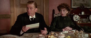Movie still from “Howards End” (1992), directed by James Ivory – A man and a woman sitting at a dinner table; Medium shot, Over the shoulder angle