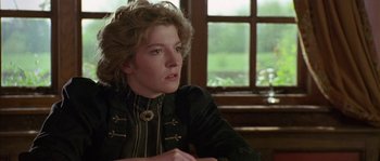 Movie still from “Howards End” (1992), directed by James Ivory – A woman sitting in front of a window looking to her left; Close Up shot, Over the shoulder angle