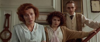 Movie still from “Howards End” (1992), directed by James Ivory – A group of three people sitting in a room together; Medium shot, Over the shoulder angle