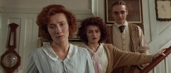 Movie still from “Howards End” (1992), directed by James Ivory – A group of people standing next to each other in a room; Close Up shot, Low angle