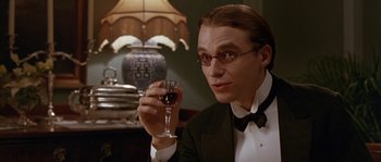 Movie still from “Howards End” (1992), directed by James Ivory – A man holding a glass of wine in his hand; Close Up shot, Low angle