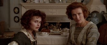 Movie still from “Howards End” (1992), directed by James Ivory – Two women standing next to each other in front of a fireplace; Close Up shot, Over the shoulder angle