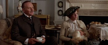 Movie still from “Howards End” (1992), directed by James Ivory – A man and a woman sitting in a living room; Medium shot, Low angle