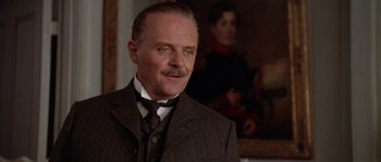 Movie still from “Howards End” (1992), directed by James Ivory – An older man wearing a suit and a tie; Close Up shot, Low angle