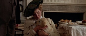 Movie still from “Howards End” (1992), directed by James Ivory – A woman holding a puppy in her arms; Close Up shot, Low angle