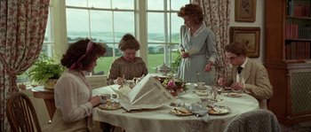 Movie still from “Howards End” (1992), directed by James Ivory – A group of people sitting around a table; Medium shot, High angle