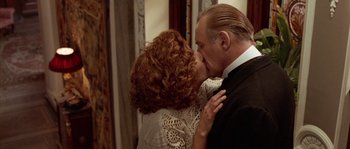 Movie still from “Howards End” (1992), directed by James Ivory – A man and a woman kissing each other in front of a mirror; Close Up shot, Low angle