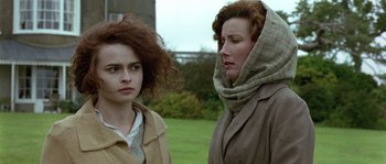 Movie still from “Howards End” (1992), directed by James Ivory – Two women standing next to each other on a field; Close Up shot, Over the shoulder angle