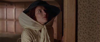 Movie still from “Howards End” (1992), directed by James Ivory – A woman wearing a black hat and a tan jacket; Close Up shot, Low angle