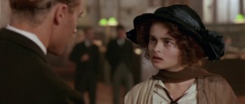 Movie still from “Howards End” (1992), directed by James Ivory – A young woman in a hat and a dress; Close Up shot, Over the shoulder angle
