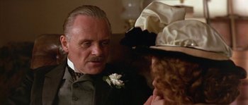 Movie still from “Howards End” (1992), directed by James Ivory – A person wearing a suit and a hat; Close Up shot, Over the shoulder angle
