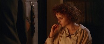 Movie still from “Howards End” (1992), directed by James Ivory – A woman with curly hair is looking at her reflection in a mirror; Close Up shot, Over the shoulder angle