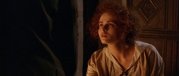 Movie still from “Howards End” (1992), directed by James Ivory – A woman with curly red hair is looking up; Close Up shot, Over the shoulder angle