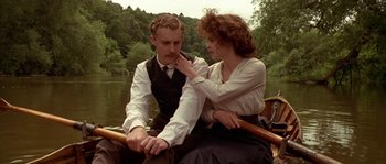Movie still from “Howards End” (1992), directed by James Ivory – A man and a woman sitting in a boat on a river; Medium shot, Low angle