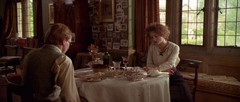 Movie still from “Howards End” (1992), directed by James Ivory – Two people sitting at a table with food on it; Medium shot, Over the shoulder angle
