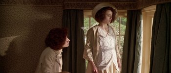 Movie still from “Howards End” (1992), directed by James Ivory – Two women standing next to each other near a window; Medium shot, Low angle