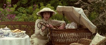 Movie still from “Howards End” (1992), directed by James Ivory – A woman sitting on top of a wicker basket; Medium shot, High angle