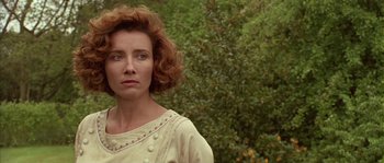 Movie still from “Howards End” (1992), directed by James Ivory – A person wearing a white shirt near a tree; Close Up shot, Low angle