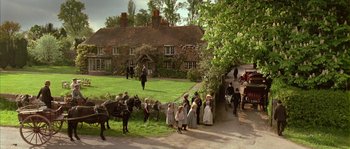 Movie still from “Howards End” (1992), directed by James Ivory – A group of people standing next to a horse drawn carriage; Extreme Wide shot, High angle