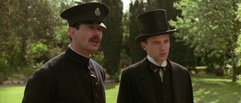 Movie still from “Howards End” (1992), directed by James Ivory – Two men in top hats standing next to each other; Close Up shot, Low angle