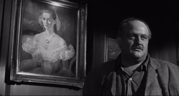 Movie still from “Hush...Hush, Sweet Charlotte” (1964), directed by Robert Aldrich – A man standing next to a painting of a woman; Close Up shot, Over the shoulder angle