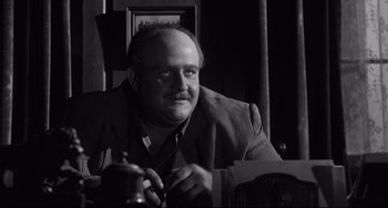 Movie still from “Hush...Hush, Sweet Charlotte” (1964), directed by Robert Aldrich – Black and white photograph of a man sitting at a table; Close Up shot, Low angle