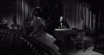 Movie still from “Hush...Hush, Sweet Charlotte” (1964), directed by Robert Aldrich – A man and a woman sitting at a dinner table; Wide shot, Over the shoulder angle