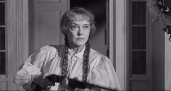 Movie still from “Hush...Hush, Sweet Charlotte” (1964), directed by Robert Aldrich – An older woman holding a pair of long braids; Close Up shot, Over the shoulder angle