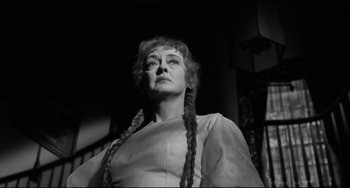 Movie still from “Hush...Hush, Sweet Charlotte” (1964), directed by Robert Aldrich – An old photo of a woman with plaited hair looking up; Close Up shot, Low angle