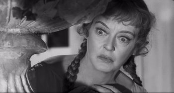 Movie still from “Hush...Hush, Sweet Charlotte” (1964), directed by Robert Aldrich – A woman with a bird on her shoulder looking at the camera; Close Up shot, Over the shoulder angle