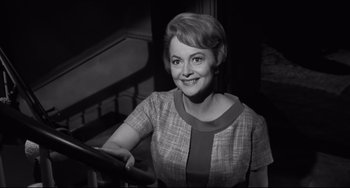 Movie still from “Hush...Hush, Sweet Charlotte” (1964), directed by Robert Aldrich – An old photo of a woman smiling for the camera; Medium shot, High angle