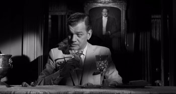 Movie still from “Hush...Hush, Sweet Charlotte” (1964), directed by Robert Aldrich – A black and white photo of a man sitting at a table; Medium shot, Over the shoulder angle