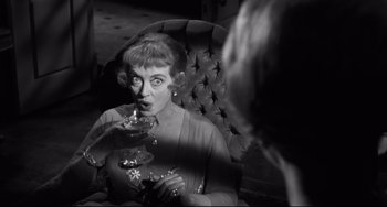Movie still from “Hush...Hush, Sweet Charlotte” (1964), directed by Robert Aldrich – An older woman drinking a glass of red wine; Close Up shot, Over the shoulder angle