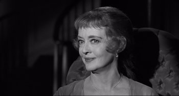 Movie still from “Hush...Hush, Sweet Charlotte” (1964), directed by Robert Aldrich – An older woman is smiling for the camera; Close Up shot, Over the shoulder angle