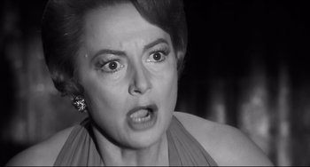 Movie still from “Hush...Hush, Sweet Charlotte” (1964), directed by Robert Aldrich – An old photo of a woman making an angry face; Close Up shot, Low angle