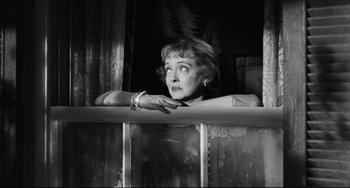 Movie still from “Hush...Hush, Sweet Charlotte” (1964), directed by Robert Aldrich – An old photo of a woman looking out of a window; Close Up shot, Low angle