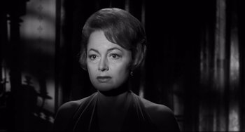 Movie still from “Hush...Hush, Sweet Charlotte” (1964), directed by Robert Aldrich – An old photo of a woman in a black dress; Close Up shot, Low angle