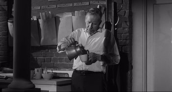 Movie still from “Hush...Hush, Sweet Charlotte” (1964), directed by Robert Aldrich – A black and white photo of a man pouring a cup of coffee; Medium shot, High angle