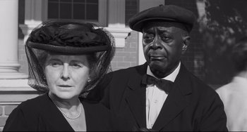 Movie still from “Hush...Hush, Sweet Charlotte” (1964), directed by Robert Aldrich – An older man and woman dressed up in a black and white photo; Close Up shot, Low angle