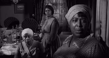 Movie still from “Hush...Hush, Sweet Charlotte” (1964), directed by Robert Aldrich – A group of women standing next to each other in a living room; Medium shot, Low angle