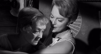 Movie still from “Hush...Hush, Sweet Charlotte” (1964), directed by Robert Aldrich – A woman is hugging another woman in a black and white photo; Close Up shot, High angle