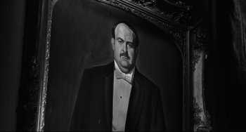 Movie still from “Hush...Hush, Sweet Charlotte” (1964), directed by Robert Aldrich – A black - and - white photo of a man in a tuxedo; Medium shot, Low angle