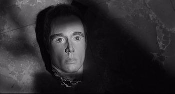 Movie still from “Hush...Hush, Sweet Charlotte” (1964), directed by Robert Aldrich – A black and white photo of a man's face; Close Up shot, Overhead angle