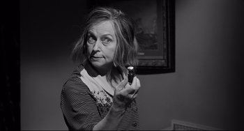 Movie still from “Hush...Hush, Sweet Charlotte” (1964), directed by Robert Aldrich – An older woman is holding a cigarette in her hand; Close Up shot, Over the shoulder angle