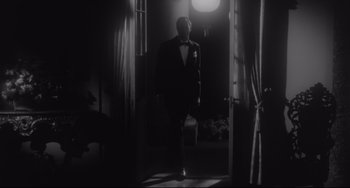 Movie still from “Hush...Hush, Sweet Charlotte” (1964), directed by Robert Aldrich – A black and white photo of a man in a suit; Wide shot, Low angle