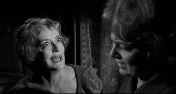 Movie still from “Hush...Hush, Sweet Charlotte” (1964), directed by Robert Aldrich – Two women talking to each other in front of a curtain; Close Up shot, Over the shoulder angle