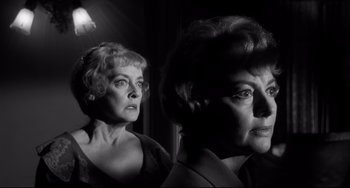 Movie still from “Hush...Hush, Sweet Charlotte” (1964), directed by Robert Aldrich – Two older women standing next to each other in a dimly - lit room; Close Up shot, Low angle