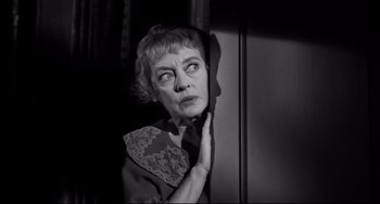 Movie still from “Hush...Hush, Sweet Charlotte” (1964), directed by Robert Aldrich – An older woman looking out of a window; Close Up shot, Low angle