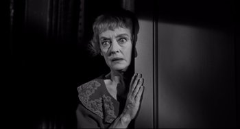 Movie still from “Hush...Hush, Sweet Charlotte” (1964), directed by Robert Aldrich – An older woman with her hands clasped in front of her face; Close Up shot, Low angle